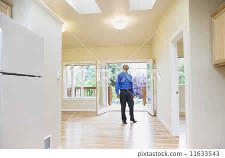 Asian man looking around new house Asian man looking around new house 11633543