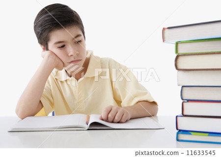 Student surveying stack of books to read Student surveying stack of books to read 11633545