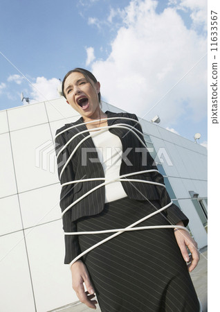 Businesswoman tied up and yelling Businesswoman tied up and yelling 11633567
