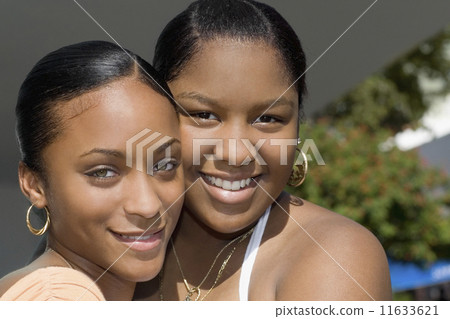 African teenaged girls hugging African teenaged girls hugging 11633621