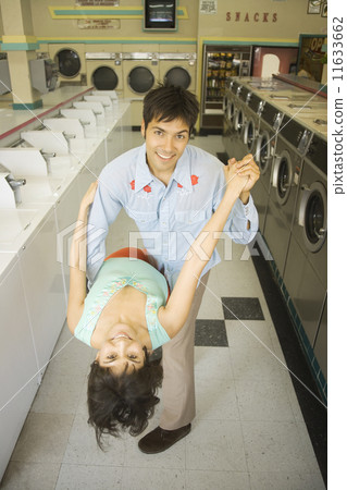 Couple dancing in a laundromat 11633662