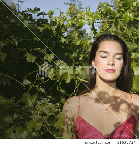 Hispanic woman with eyes closed 11633724