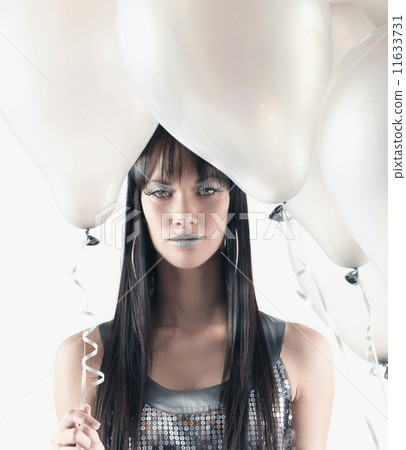 Pacific Islander woman holding balloons Pacific Islander woman holding balloons 11633731
