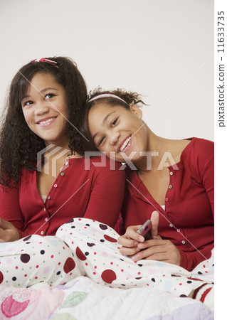 African twin sisters hugging 11633735