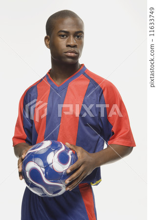 African American male soccer player holding ball 11633749