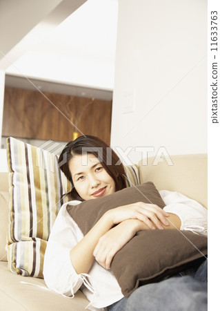 Asian woman hugging pillow 11633763