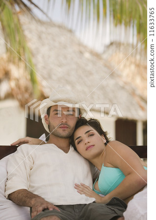 Couple relaxing on a couch outdoors 11633765