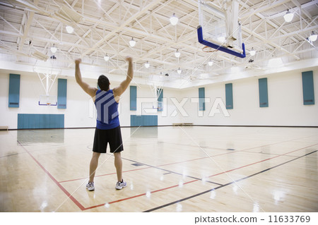 Man cheering on basketball court 11633769