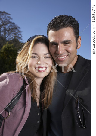 Hispanic couple hugging outdoors Hispanic couple hugging outdoors 11633773