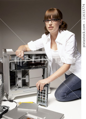Hispanic woman installing computer hardware Hispanic woman installing computer hardware 11633774