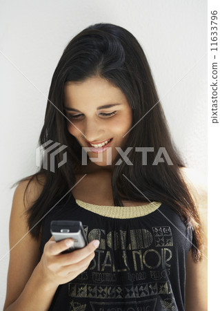 South American woman looking at cell phone South American woman looking at cell phone 11633796