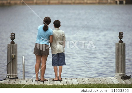 Mixed Race brother and sister on dock Mixed Race brother and sister on dock 11633803