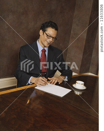Hispanic businessman writing Hispanic businessman writing 11633806