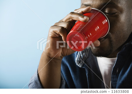 African man drinking from plastic cup African man drinking from plastic cup 11633808