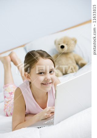 Hispanic girl typing on laptop Hispanic girl typing on laptop 11633815