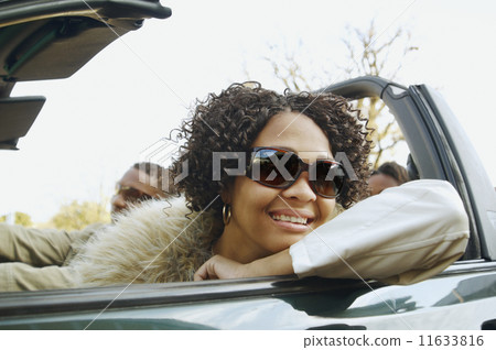 African couple driving in convertible car 11633816