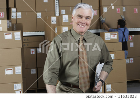 Businessman standing in warehouse Businessman standing in warehouse 11633828