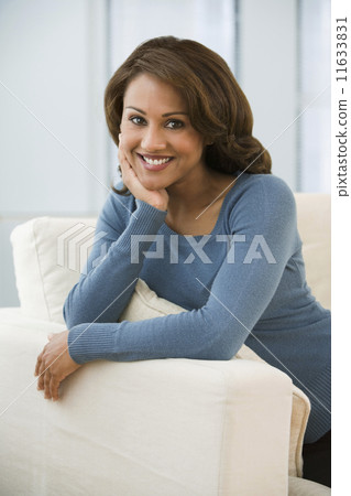 Hispanic woman sitting in chair Hispanic woman sitting in chair 11633831