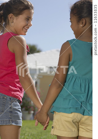 Mixed Race sisters holding hands 11633835