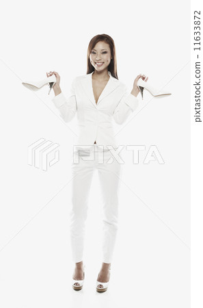 Asian woman holding pair of shoes 11633872