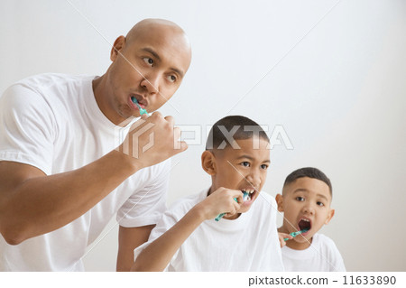 Indian father and sons brushing teeth Indian father and sons brushing teeth 11633890
