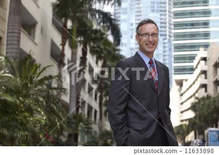 Caucasian businessman with hands in pockets Caucasian businessman with hands in pockets 11633898