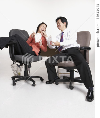 Studio shot of Asian businesspeople eating take out Studio shot of Asian businesspeople eating take out 11633913