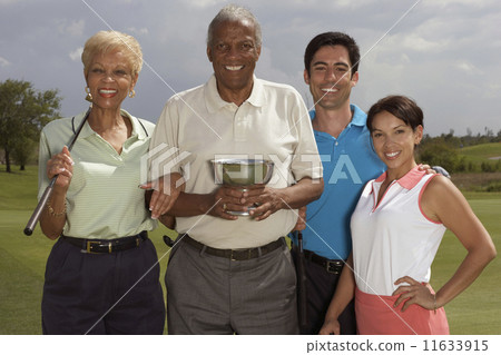 Multi-ethnic couples holding golf trophy 11633915
