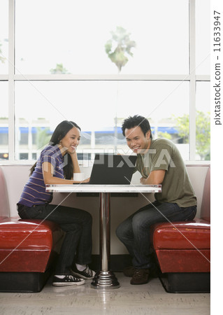 Asian couple looking at laptop 11633947