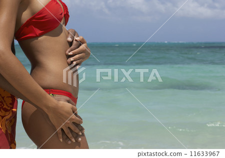 Hispanic couple hugging at beach Hispanic couple hugging at beach 11633967