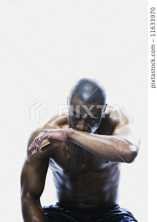 Sweaty African man sitting  11633970