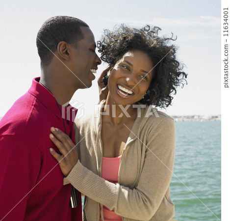 African couple hugging at beach African couple hugging at beach 11634001