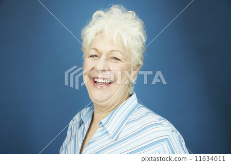 Studio shot of senior woman laughing 11634011