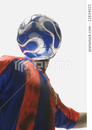 African American male soccer player with ball in front of face 11634025