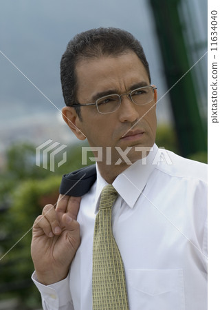 Hispanic businessman with jacket over shoulder Hispanic businessman with jacket over shoulder 11634040