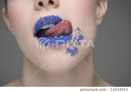 Woman licking sprinkles off lips 11634053