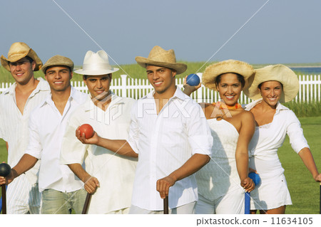 Multi-ethnic friends playing croquet Multi-ethnic friends playing croquet 11634105