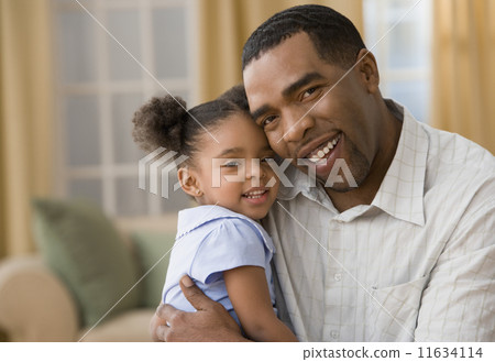 Mixed Race father and daughter hugging 11634114