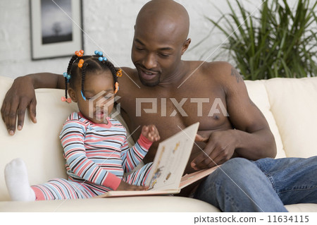 African father reading to daughter 11634115