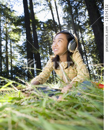 Asian girl listening to headphones 11634132