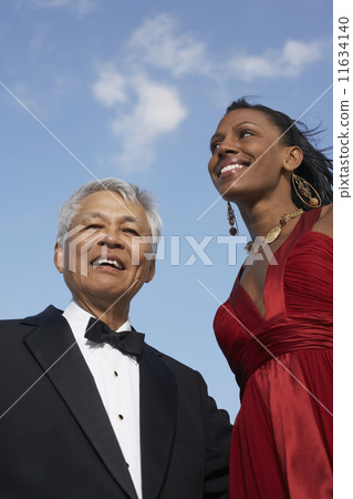 Low angle view of Mixed Race woman and senior man Low angle view of Mixed Race woman and senior man 11634140