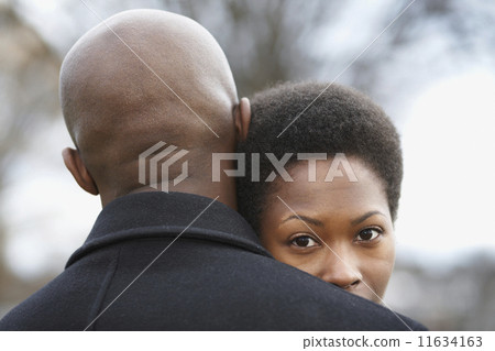 Close up of African couple hugging 11634163