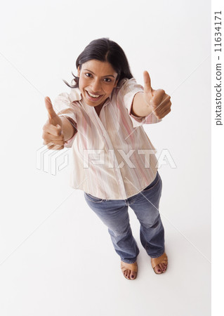 High angle view of Indian woman giving thumbs up High angle view of Indian woman giving thumbs up 11634171