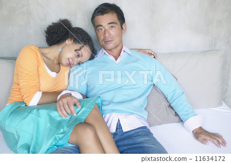 Portrait of couple sitting on couch Portrait of couple sitting on couch 11634172