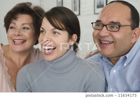 Portrait of Hispanic parents and adult daughter Portrait of Hispanic parents and adult daughter 11634173