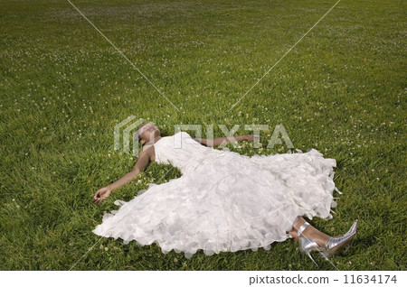 African woman laying in grass 11634174