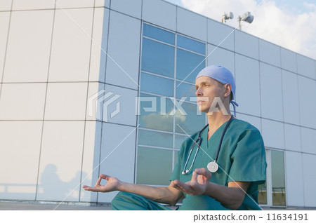 Male doctor meditating 11634191