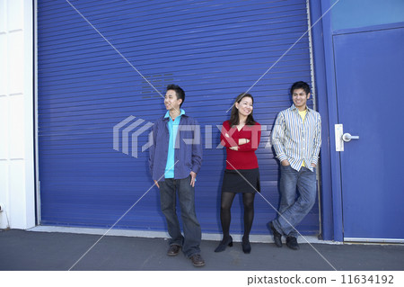 Three friends standing on sidewalk 11634192