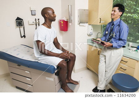 Male doctor talking to male patient 11634200