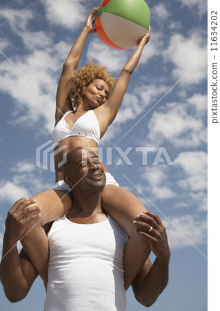 African man carrying wife on shoulders 11634202